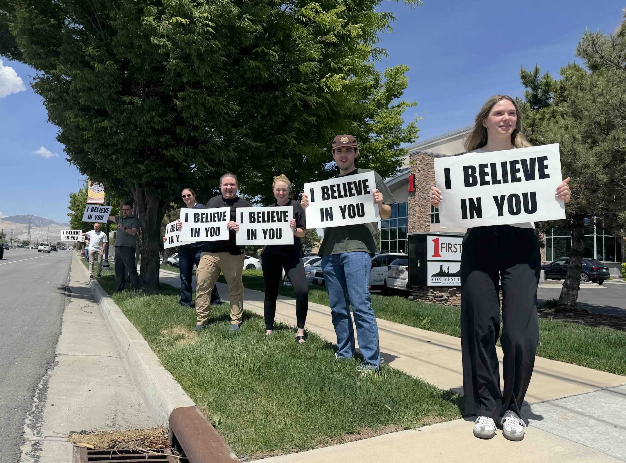 Team members showing belief signs