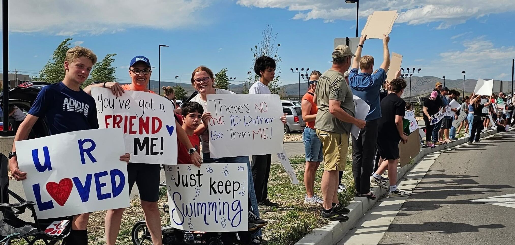 People lining the streets, investing belief for a city event.