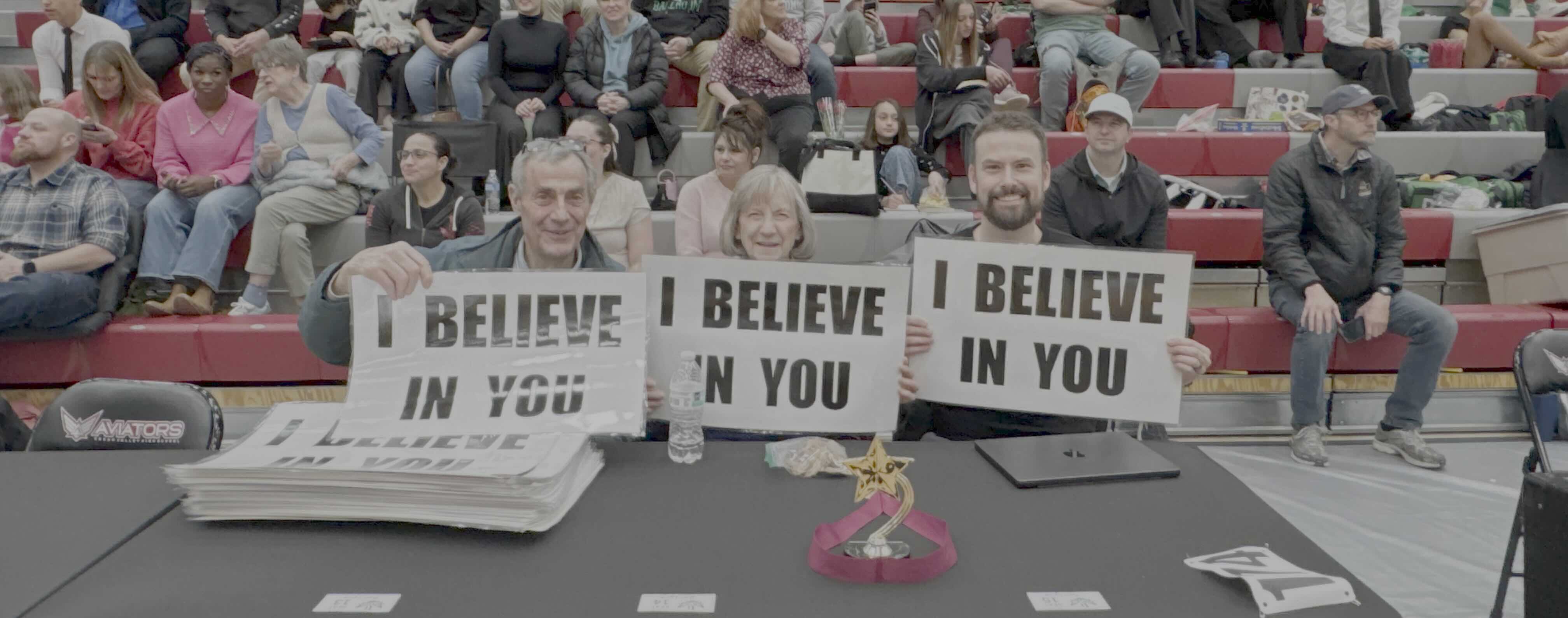 Believers holding I Believe In You signs