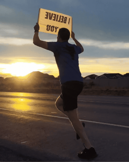 Running with the I BELIEVE IN YOU sign